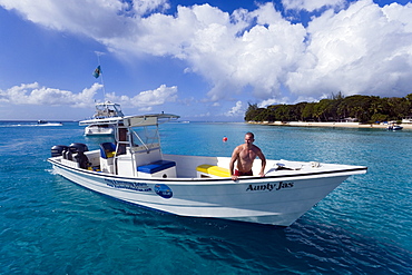 Man in a motorboat, Sandy Lane Bay, Barbados, Caribbean