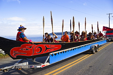 People in a canoe of Squamish Nation at Grand Parade, Makah Indian Reservation, Olympic Peninsula, Washington, USA