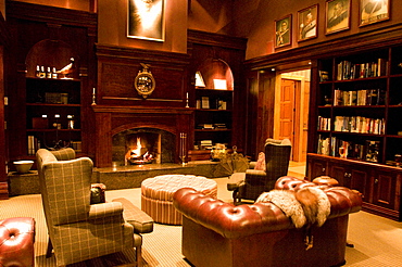 Cosy armchairs standing by the fireside at the Treetops Lodge, North Island, New Zealand, Oceania