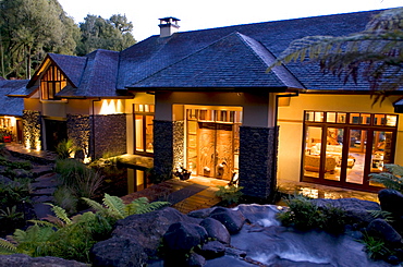 View at the illuminated windows at the Treetops Lodge in the evening, North Island, New Zealand, Oceania