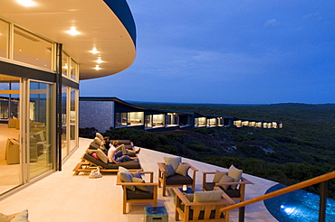 People on the illuminated terrace in front of the rooms of Southern Ocean Lodge, Kangaroo Island, South Australia, Australia