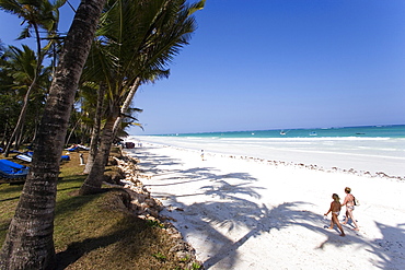 Women walking along Diani Beach, Coast, Kenya