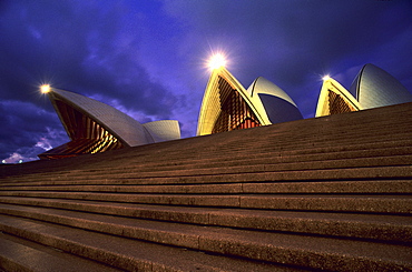 View at stairs in front of the illuminated Opera House in the evening, Sydney, New South Wales, Australia