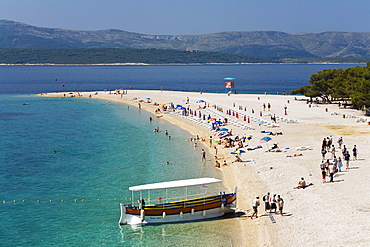 An excursion boat and people at the beach at the Golden Horn, Bol, Brac Island, Dalmatia, Croatia, Europe