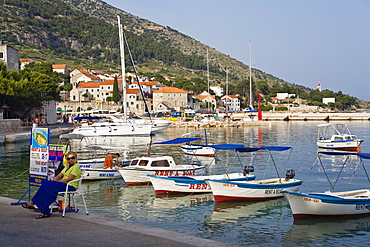 Boats are moored at Bol harbour in the sunlight, Brac Island, Dalmatia, Croatia, Europe