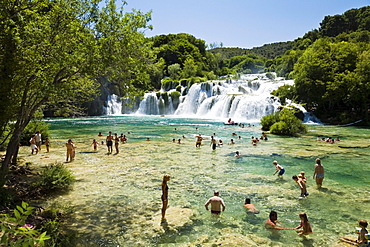 People bathing in the river at Krka waterfalls, Krka National Park, Dalmatia, Croatia, Europe