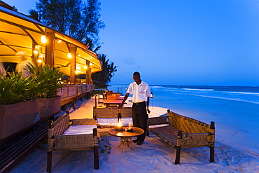 Waiter arranging lanterns, The Sands, at Nomad, Diani Beach, Kenya