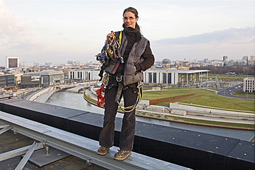 woman roof worker with equipment on central railway station, Berlin