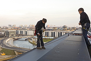 woman roof worker with equipment on central railway station, Berlin