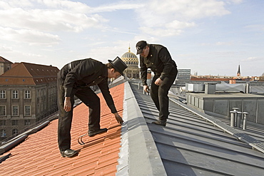 Chimney sweeps inspecting new roof, dome of New Synagogue, Berlin, Germany