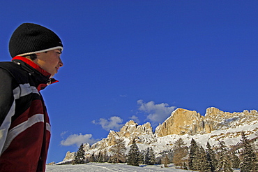 A boy and snowy mountains under blue sky, Dolomites, South Tyrol, Italy, Europe