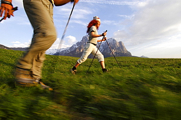 A woman and a man Nordic Walking in a mountain scenery, Sciliar, South Tyrol, Italy, Europe