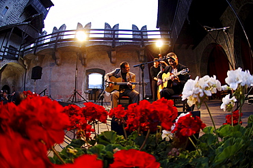 Two musicians playing the guitar at the atrium of Runkelstein castle, Bolzano, South Tyrol, Italy, Europe