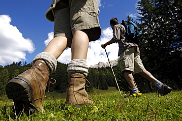 A woman and a man hiking in the mountains, South Tyrol, Italy, Europe