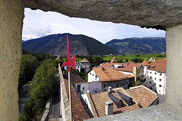 View through the city wall at the roofs of the Old Town, Glurns, Val Venosta, South Tyrol, Italy, Europe