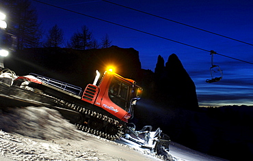 Caterpillars treating the ski slope at night, South Tyrol, Italy, Europe