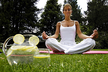 Woman sitting cross-legged, doing yoga exerceses, Meditation, Relaxation, Wellness, Holiday, South Tyrol, Italy