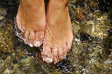 Young woman walking barefoot through a stream, Kneipp therapy, Hydrotherapy, relaxation, South Tyrol, Italy