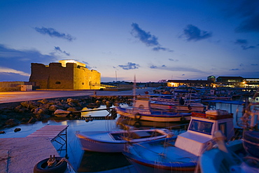 Paphos Castle at night with fishing boats, Paphos harbour, Paphos, South Cyprus, Cyprus