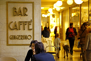 A couple sitting in Bar CaffâˆšÃ‰Â¬Â© Gingerino, Europagalerie, Bolzano, South Tyrol, Italy