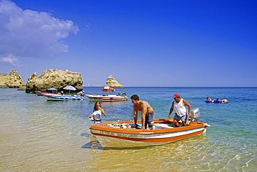 People in an excursion boat at the beach, Praia de Dona Ana, Algarve, Portugal, Europe