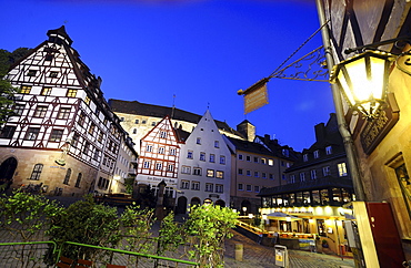 Half-timber houses with castle in background in the evening, Nuremberg, Middle Franconia, Bavaria, Germany