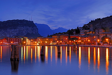 View over lake Garda to illuminated Nago-Torbole, Trentino-Alto Adige/Suedtirol, Italy