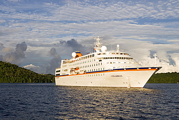 Cruiseship MV Columbus raising anchor in the light of the evening sun, Vava'u archipelago, Tonga, South Pacific, Oceania