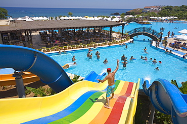 Young man on a water slide, water park, Acapulco Beach Club and Resort Hotel, 10km east of Kyrenia, Girne, Keryneia, Cyprus