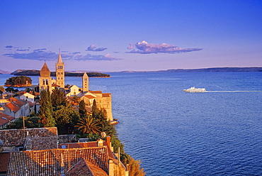 View over Bay of Kvarner to the steeples of Rab in the light of the evening sun, Rab island, Croatian Adriatic Sea, Dalmatia, Croatia, Europe