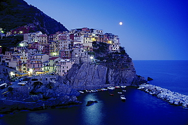 Full moon above the rocky coast at Manarola, Cinque Terre, Liguria, Italian Riviera, Italy, Europe