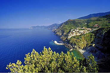 View at the coastline and Riomaggiore under blue sky, Cinque Terre, Liguria, Italian Riviera, Italy, Europe