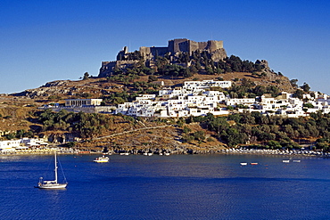 View at the town Lindos and the acropolis under blue sky, Lindos, Island of Rhodes, Greece, Europe