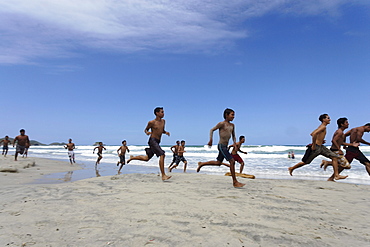 Young people running over sandy beach, Playa El Aqua, Isla Margarita, Nueva Esparta, Venezuela