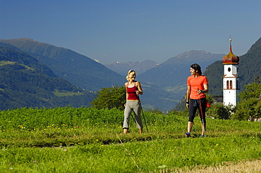 Young couple nordic walking in an idyllic landscape, Tyrol, Austria, Europe