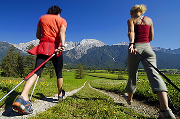 Young couple nordic walking in an idyllic landscape, Tyrol, Austria, Europe