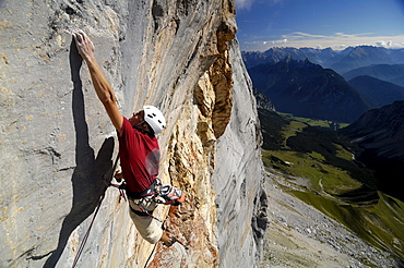 Climber at Schuesselkar rock face in the sunlight, Tyrol, Austria, Europe