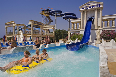 Three young people on a water slide, WaterWorld Waterpark, Agia Napa, South Cyprus, Cyprus