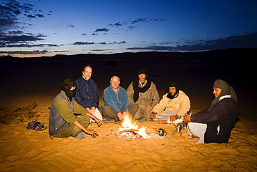 tuaregs with tourists at campfire, Libya, Africa