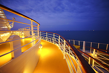Deck and railing on cruise ship AIDA Bella in the evening, Mediterranean Sea