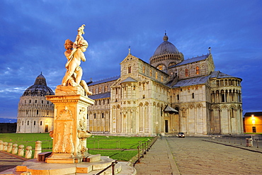 Illuminated baptistery and Pisa cathedral with fountain in the foreground, Pisa, UNESCO world heritage site, Tuscany, Italy