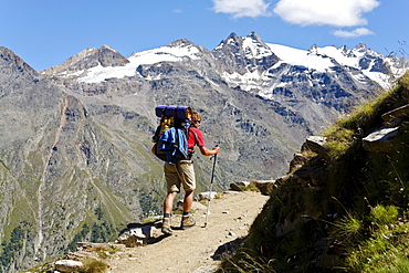 Hiker ascenting to mountain hut Rifugio Vittorio Sella, Alta Via Aosta, Gran Paradiso National Park, Aosta valley, Italy