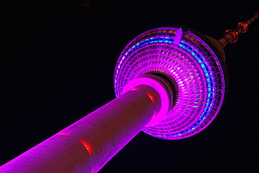 Illuminated Television Tower at night, View from foot of the tower, Berlin, Germany