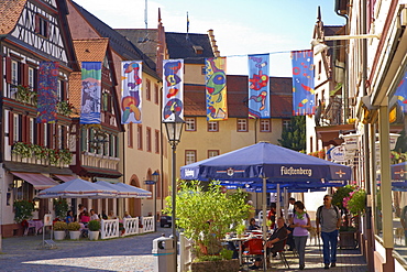 Half-timbered houses and open air restaurant in the main road of the town of Wolfach, Valley Kinzigtal, Southern Part of Black Forest, Black Forest, Baden-Wuerttemberg, Germany, Europe