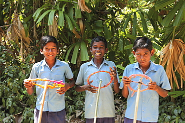 Boys in their school uniform playing car, Baratang, Middle Andaman, Andamans, India