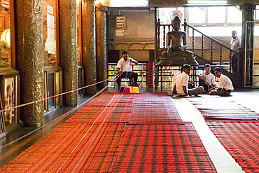 Men preparing colored blessing ribbons at the Gangaramaya temple, Colombo, Sri Lanka, Asia