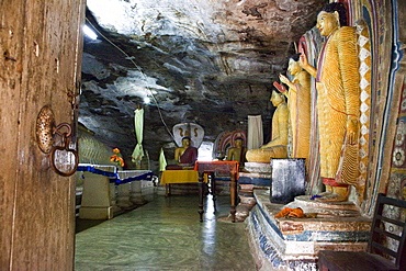 Mural paintings and Buddha statues inside of the cave monastery Rasvehera, Sri Lanka, Asia