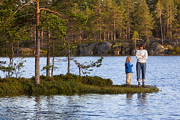 A woman and girl at the lake Taernaettvatten at the national park Skuleskogen, Hoega Kusten, Vaesternorrland, Sweden, Europe