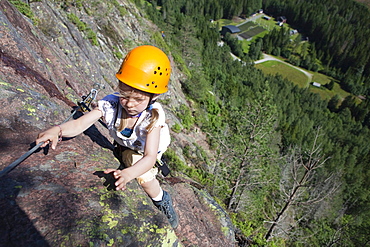 Girl climbing at fixed rope route at Skuleberget, Hoega Kusten, Vaesternorrland, Sweden, Europe