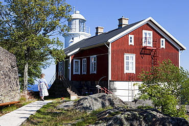 Wooden house and lighthouse Hoegbonden under blue sky, Hoega Kusten, Vaesternorrland, Sweden, Europe